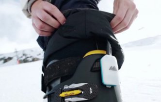 A person attaching the Carv device to their ski boot
