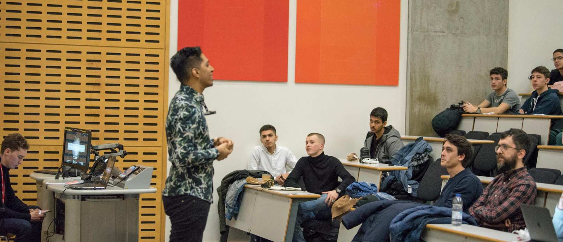 Shakir Mohamed, Deepmind, speaking. Haron and Harry on the front row on the left. Nathan Beniach, London AI, and Marco Marchesi, Happy Finish on the front row on the right.