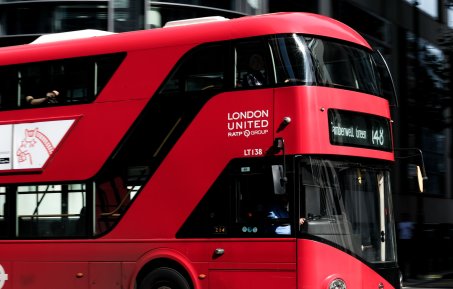 The iconic red london bus in motion