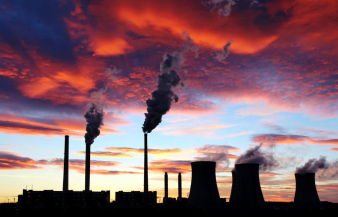 coal plant with smoke at sunset