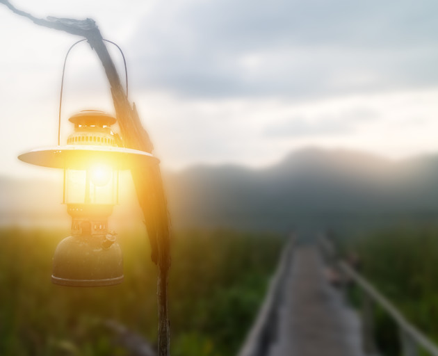 Lantern on path in rural mountain setting
