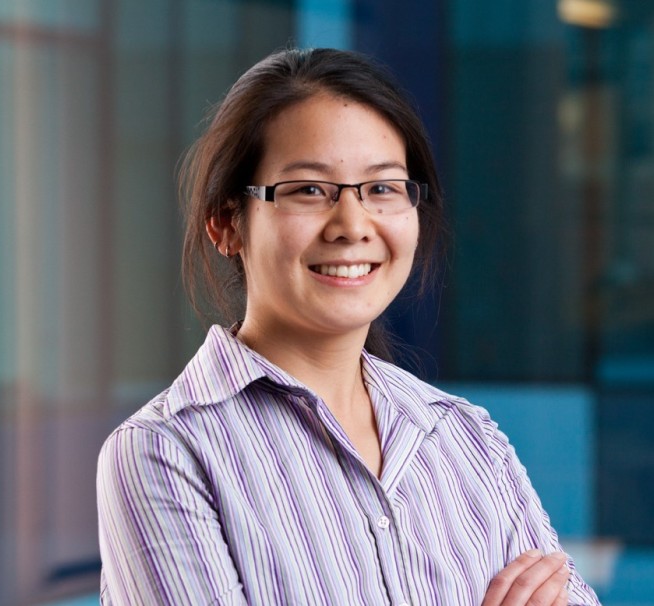 Headshot of Dr Leonora Lang (Physics 2001, PhD Mechanical Engineering 2005) standing with her arms crossed