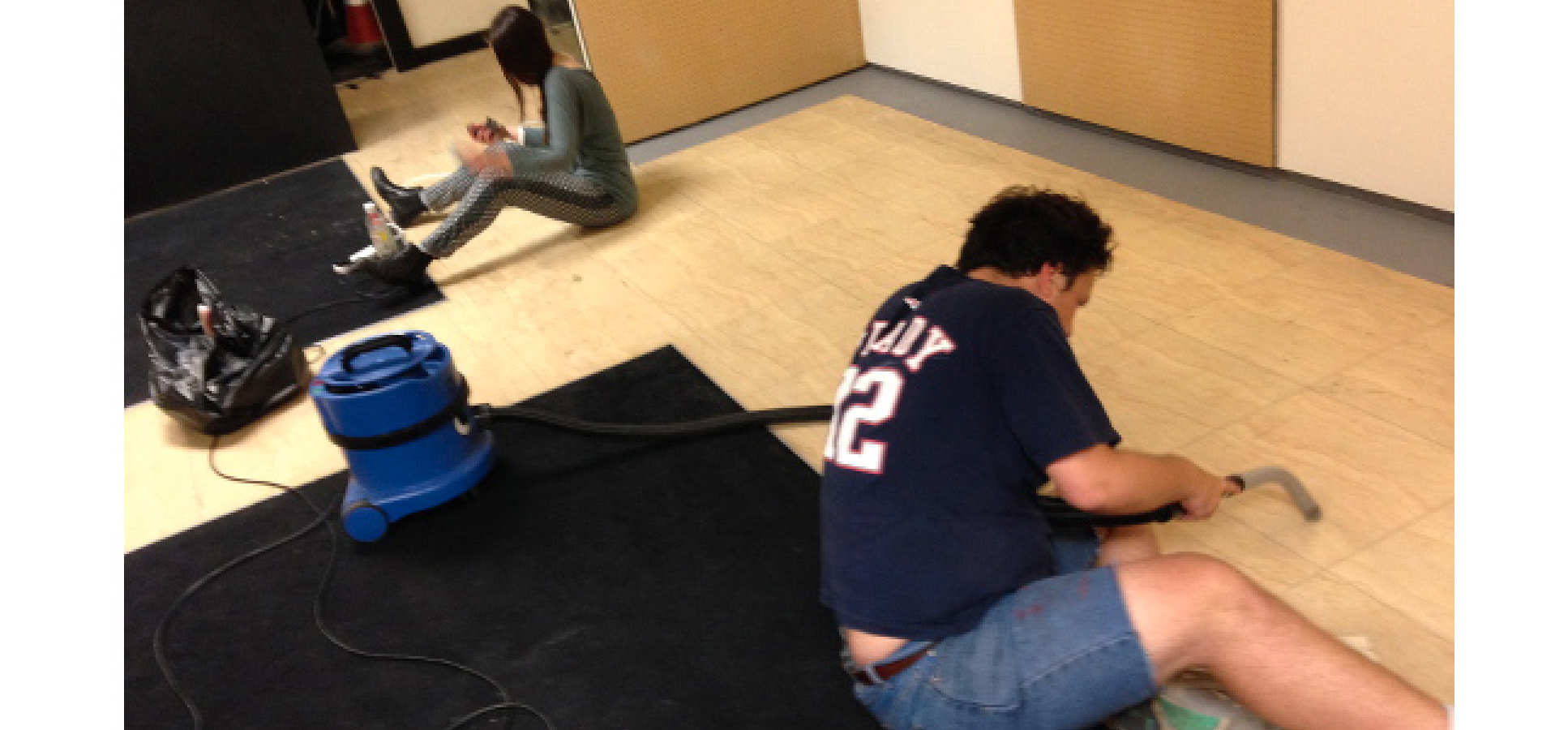 Man vacuumns floor