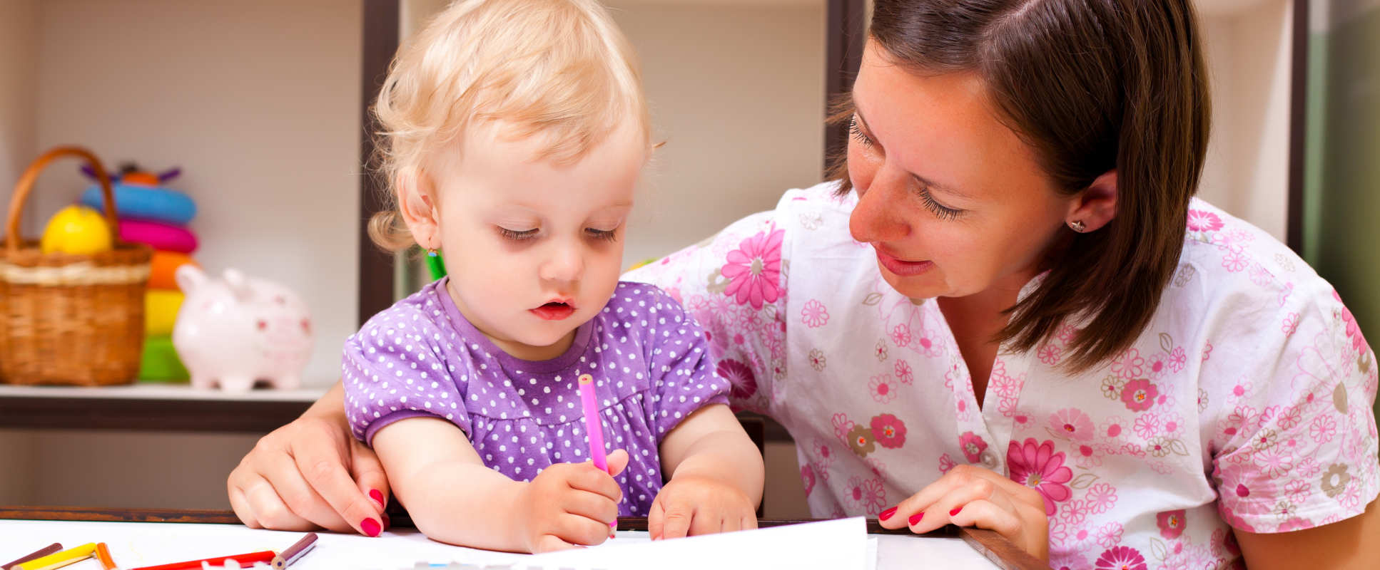 Mother looking at book with young child of two years