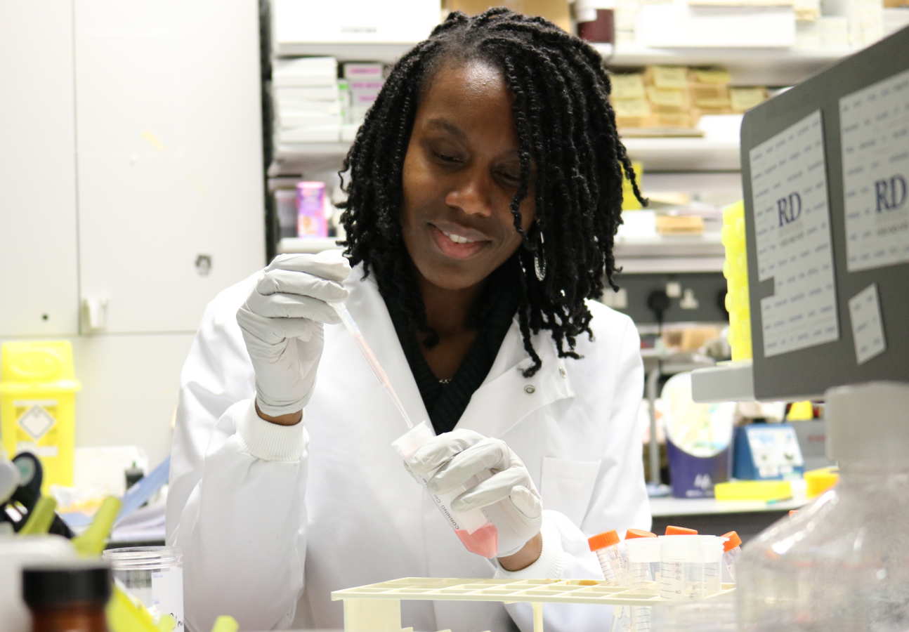 female scientist pipettes