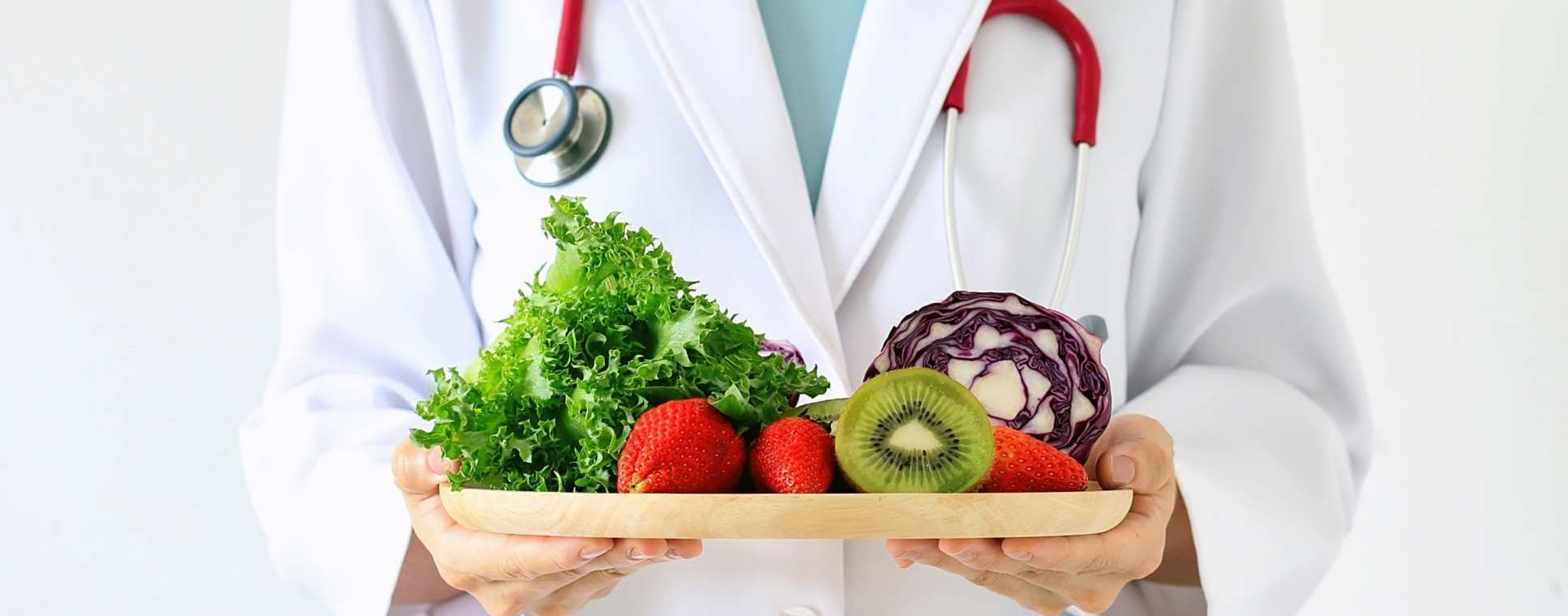 A doctor holding fruit and vegetables