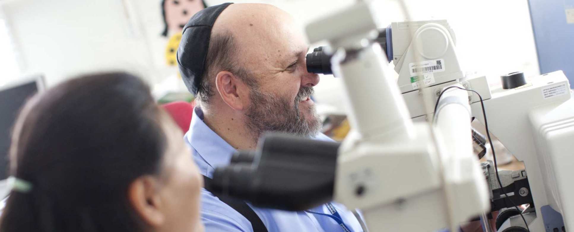 Man looking through microscope