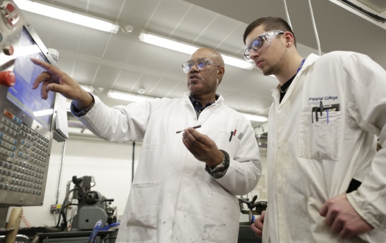 Apprentice tutor Mike Lennon demonstrates to Robert Sherer how the HAAS CNC Lathe is programmed to create precision components