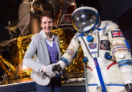 Helen Sharman shaking hands with her spacesuit