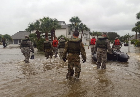 Soldiers in knee high flood water