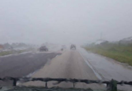 rainy road through car windscreen