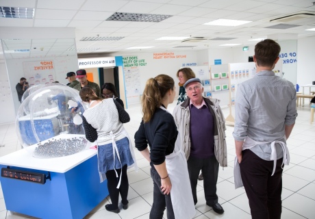 people talking with displays in background