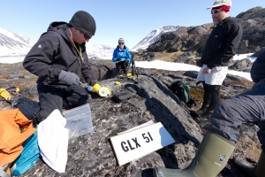 Men hammering into a rock