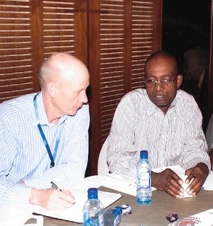 Ptrof Freemont discusses opportunities with three delegates at the workshop in Kenya