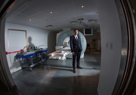 Robin Carhart-Harris stands by an MRI scanner