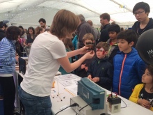 Sandrine Heutz demonstrating SPIN-Lab stand to the public