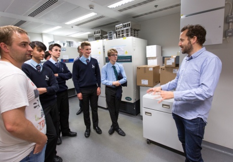 Boys listening to man talk in a lab