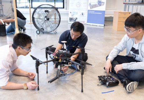 The team from Dr Kovac's Aerial Robotics Lab make final adjustments to Spider MAV before a demonstration for Oliver Moody