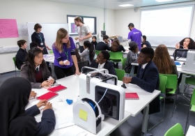 Local school pupils discussing a making technique in the classroom