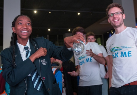 Visitor looks in amazement as she pours invisible air from a bottle