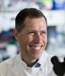 Dr Aubrey Cunnington in a lab coat smiling