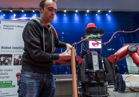 A researcher interacts with Robot DE NIRO