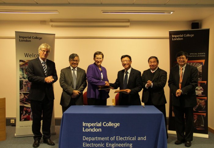 Imperial's Debra Humphris and NTU's Kam Chan Hin sign the agreement with colleagues