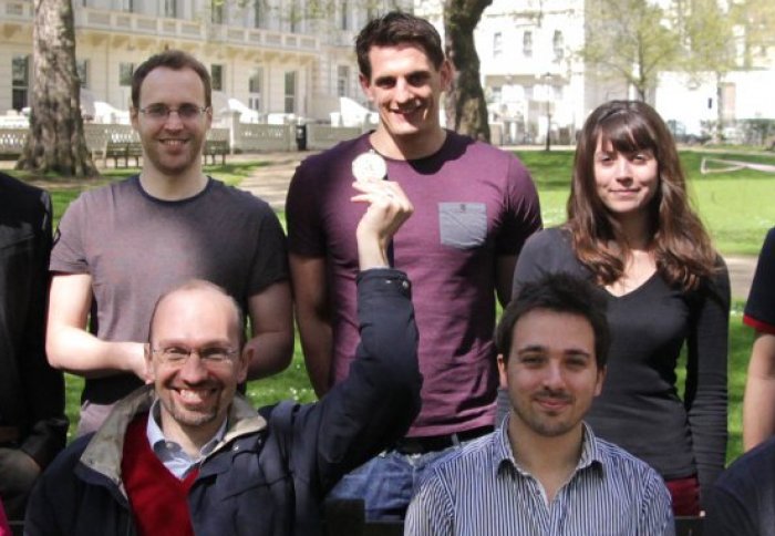 Adam (back row, middle) with his colleagues in the communications and signal processing group