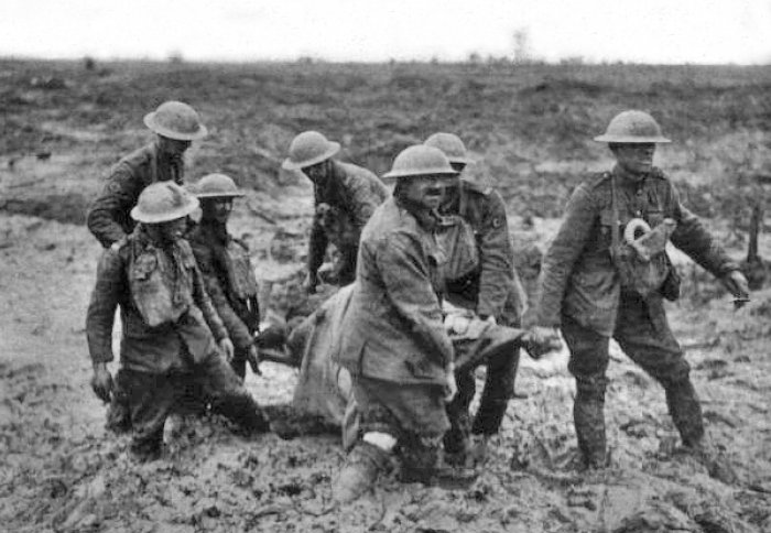 Stretcher bearers carry a wounded man through the mud at Passchendaele, August 1917