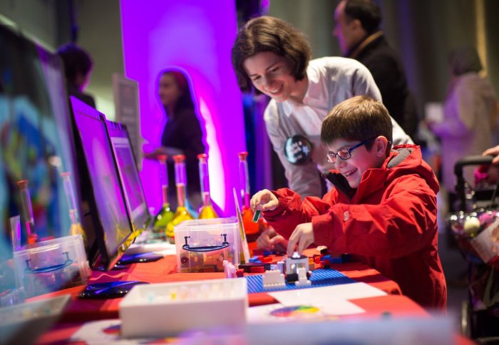 child plays with LEGO spectrometer at the Fringe