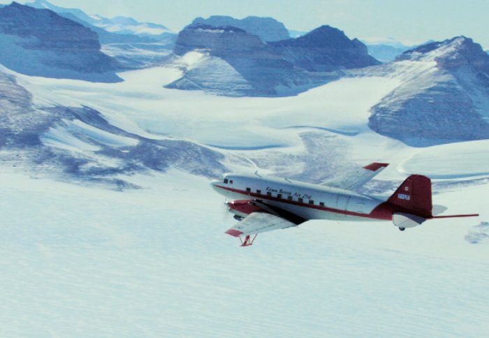 Plane flying over a glacier