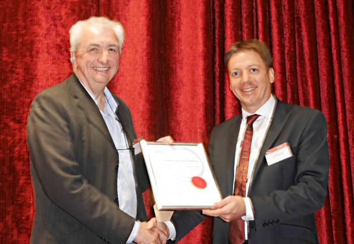 Professor Paul Luckham receiving the Sir Eric Rideal Award from is Dr. Malcolm Faers