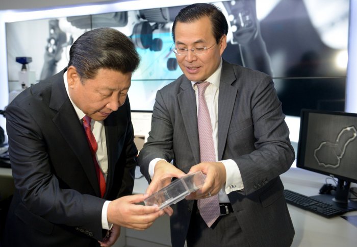 President Xi Jinping learning about a nano replica of the Great Wall of China with Professor Guang-Zhong Yang