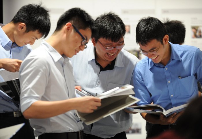 Staff and students take a look at the anniversary book