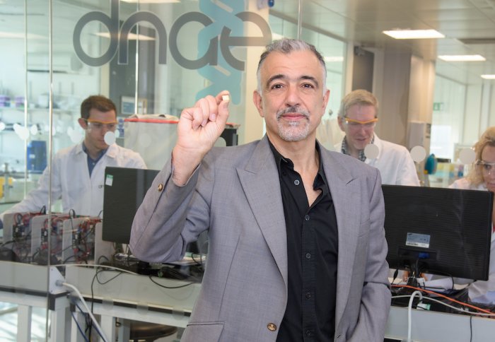 Professor Chris Toumazou holding the Genalysis chip