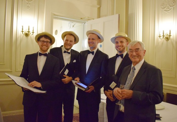 Professor Alan Fenwick standing beside a Barbershop Quartet