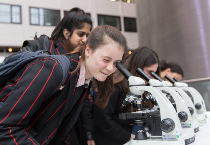 Students looking into microscope