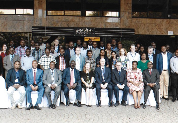 Delegates of the conference pose for a group photo outside the venue