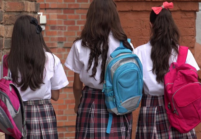 Three school girls walking to class