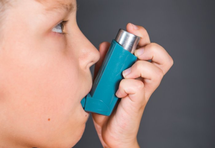 Experts are calling for a shake up in how asthma is classified and treated. Pictured is a child using an inhaler