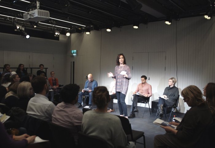 An audience member reading the True Cut programme