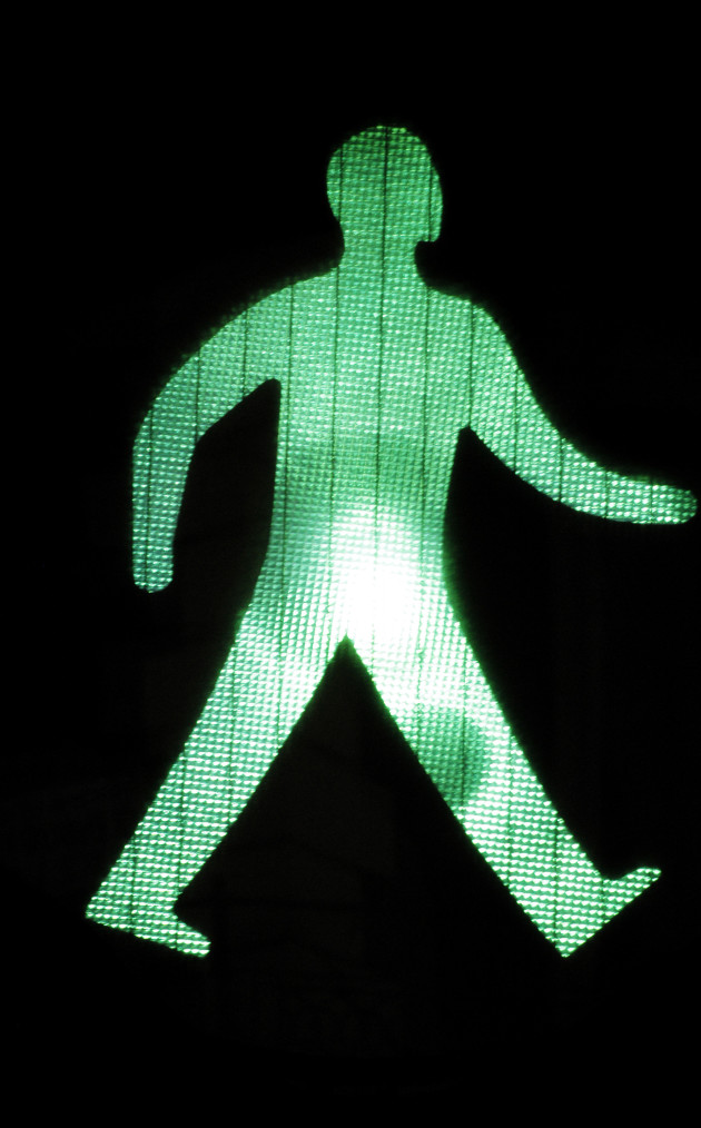 Green pedestrian light walking man, close up