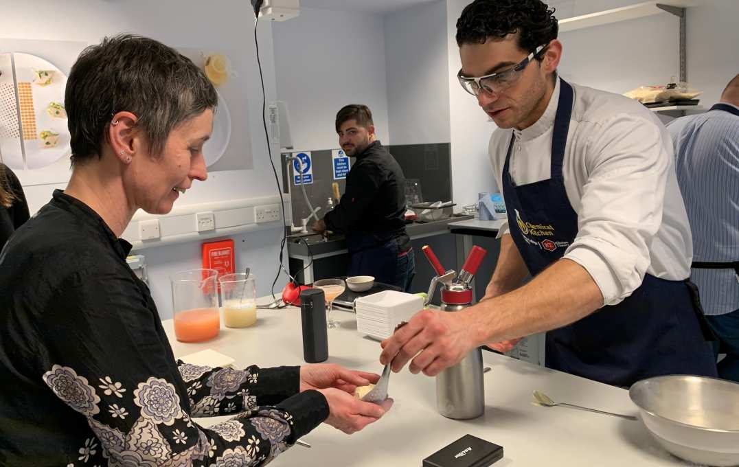 Professor Emma McCoy, FoNS Vice-Dean (Education), learns how to make passion fruit ice cream using liquid nitrogen.