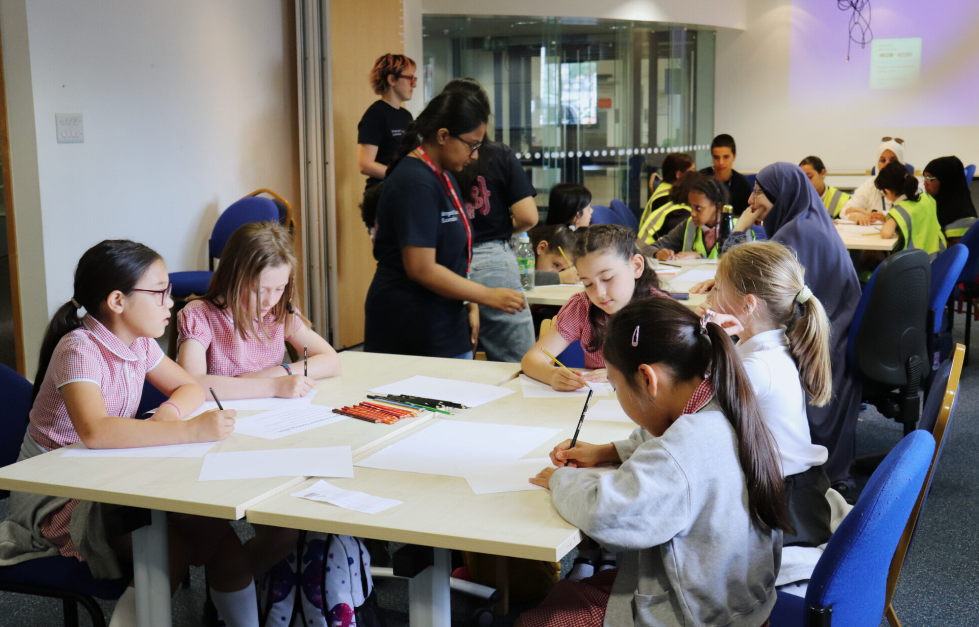 Young girls drawing at the Hello World Hack