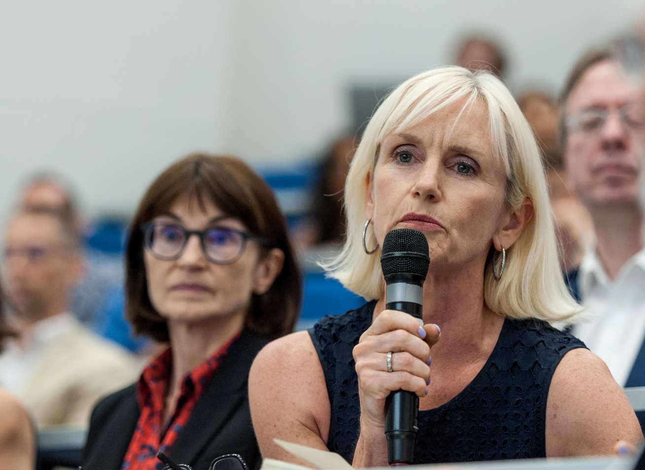 Woman asks question at Q&A