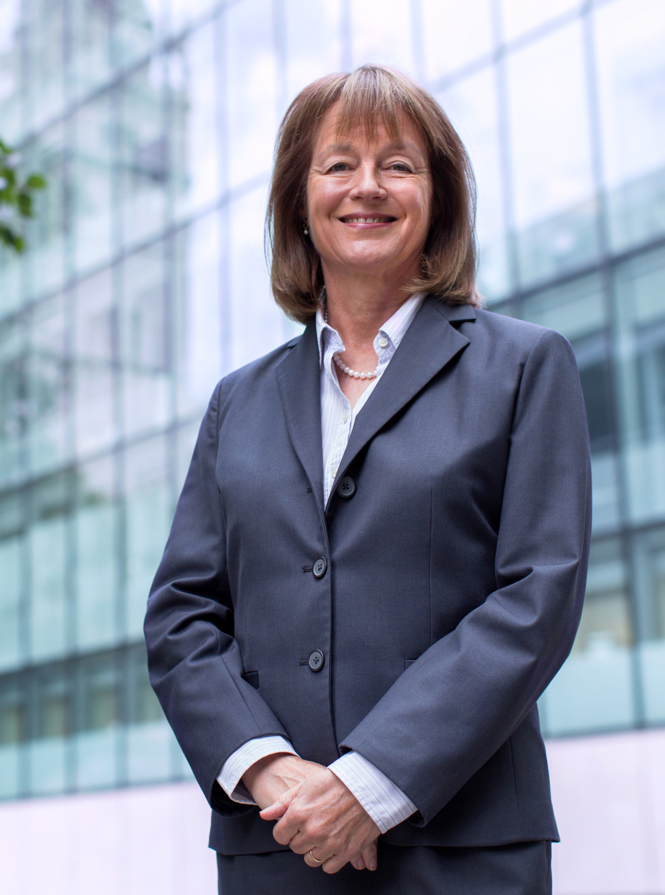 Professor Alice Gast standing at the main entrance to the College