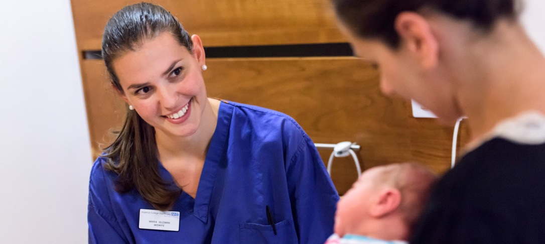 Picture of a nurse who is looking at a mother and child 