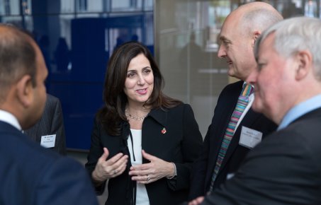 Academics and business professionals talking in the main entrance of Imperial College
