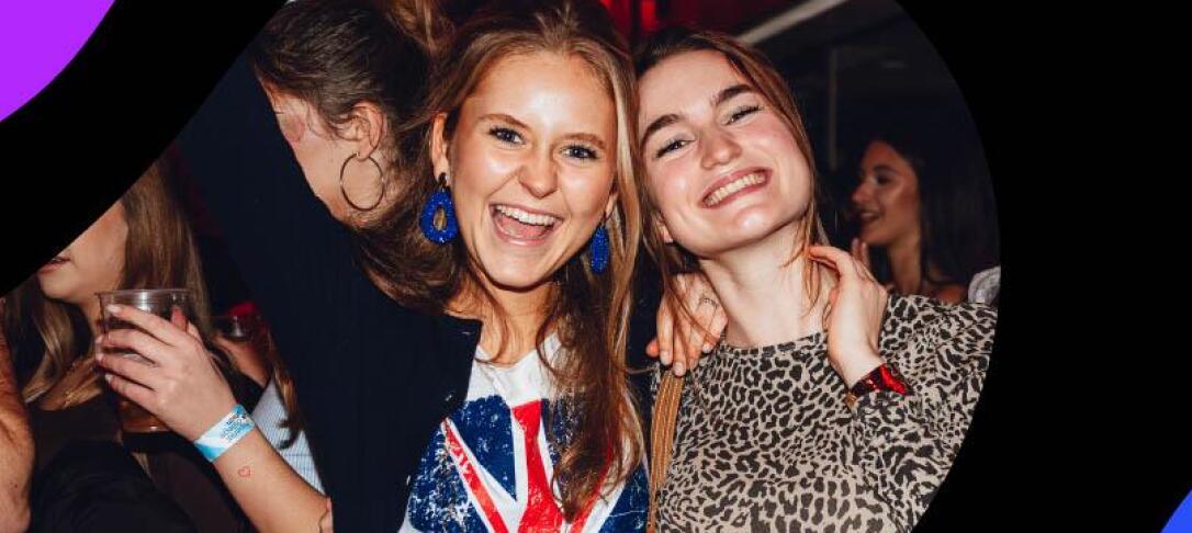 Two students smiling into the camera partying at an ICU event