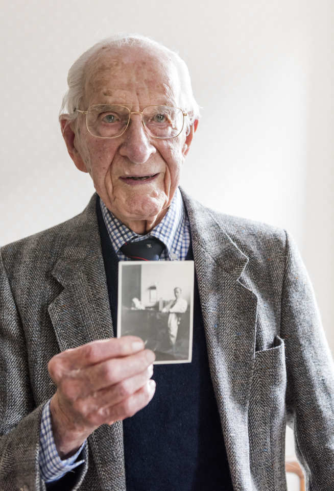 Dr Frankland pictured with a photograph of him as a junior doctor